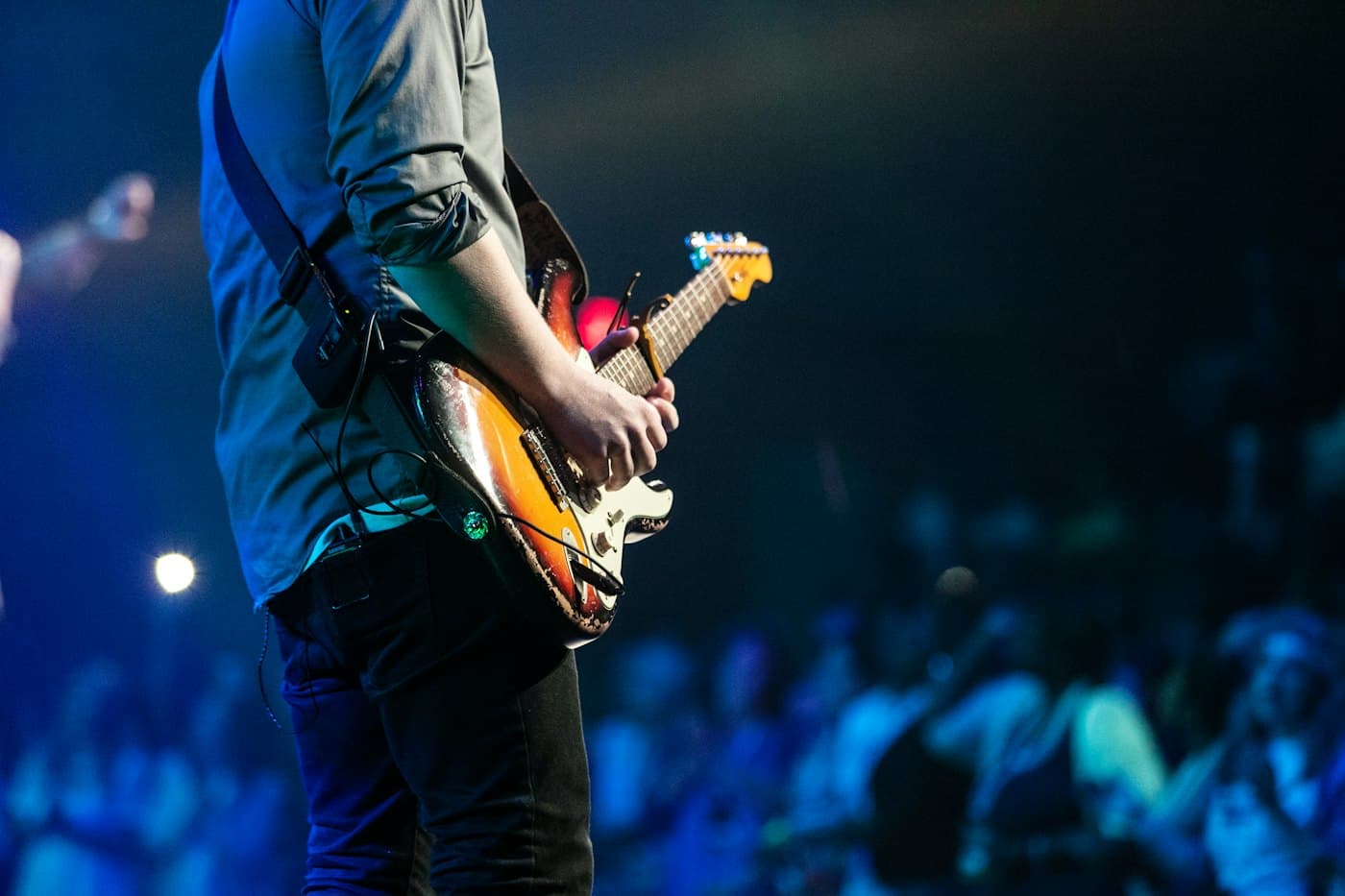 A guitarist performing for a seated audience